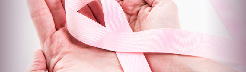 Two hands holding a pink ribbon